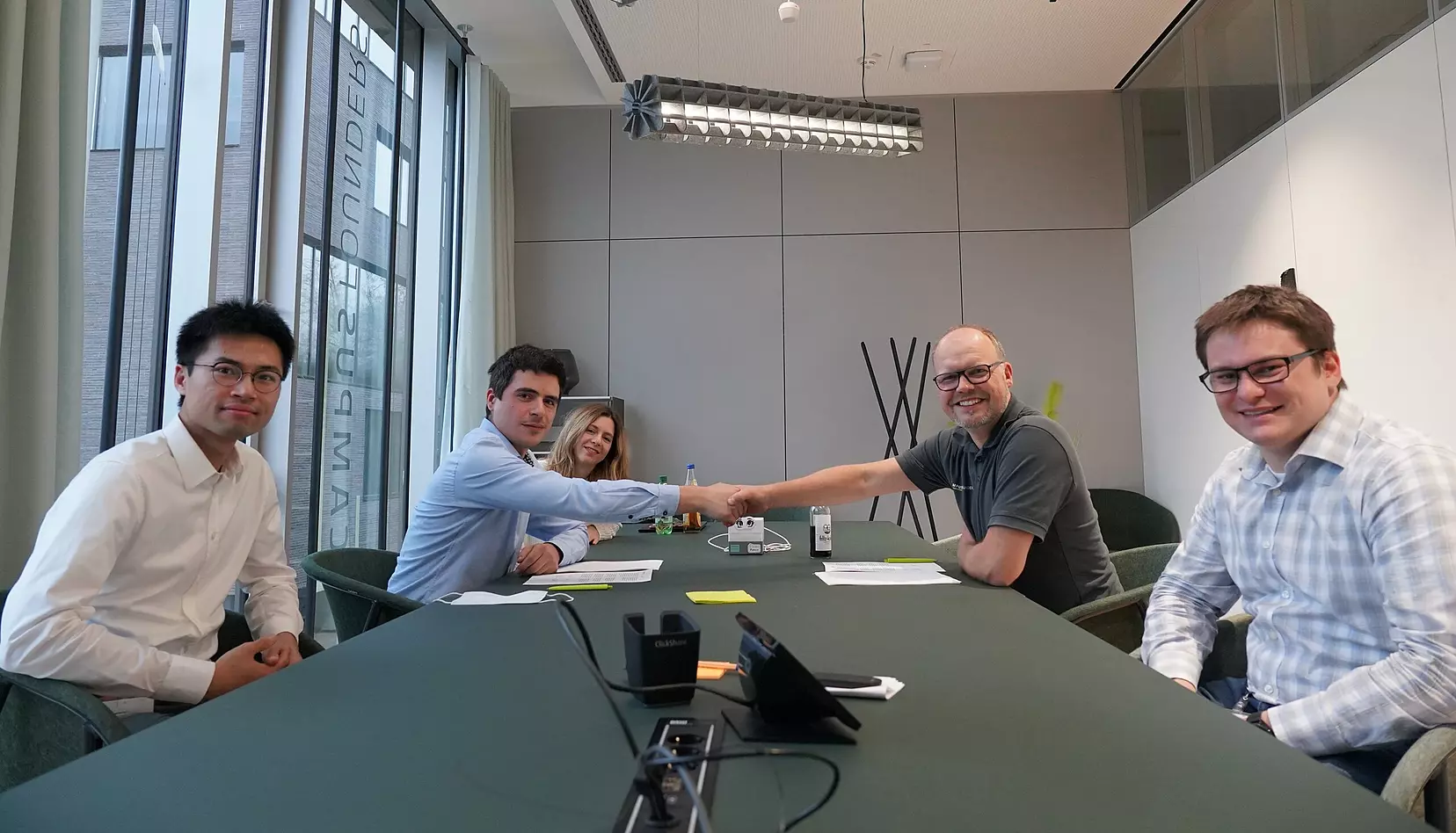 IUNA AI team signing funding agreement with Campus Founders and WOLFMAN.ONE