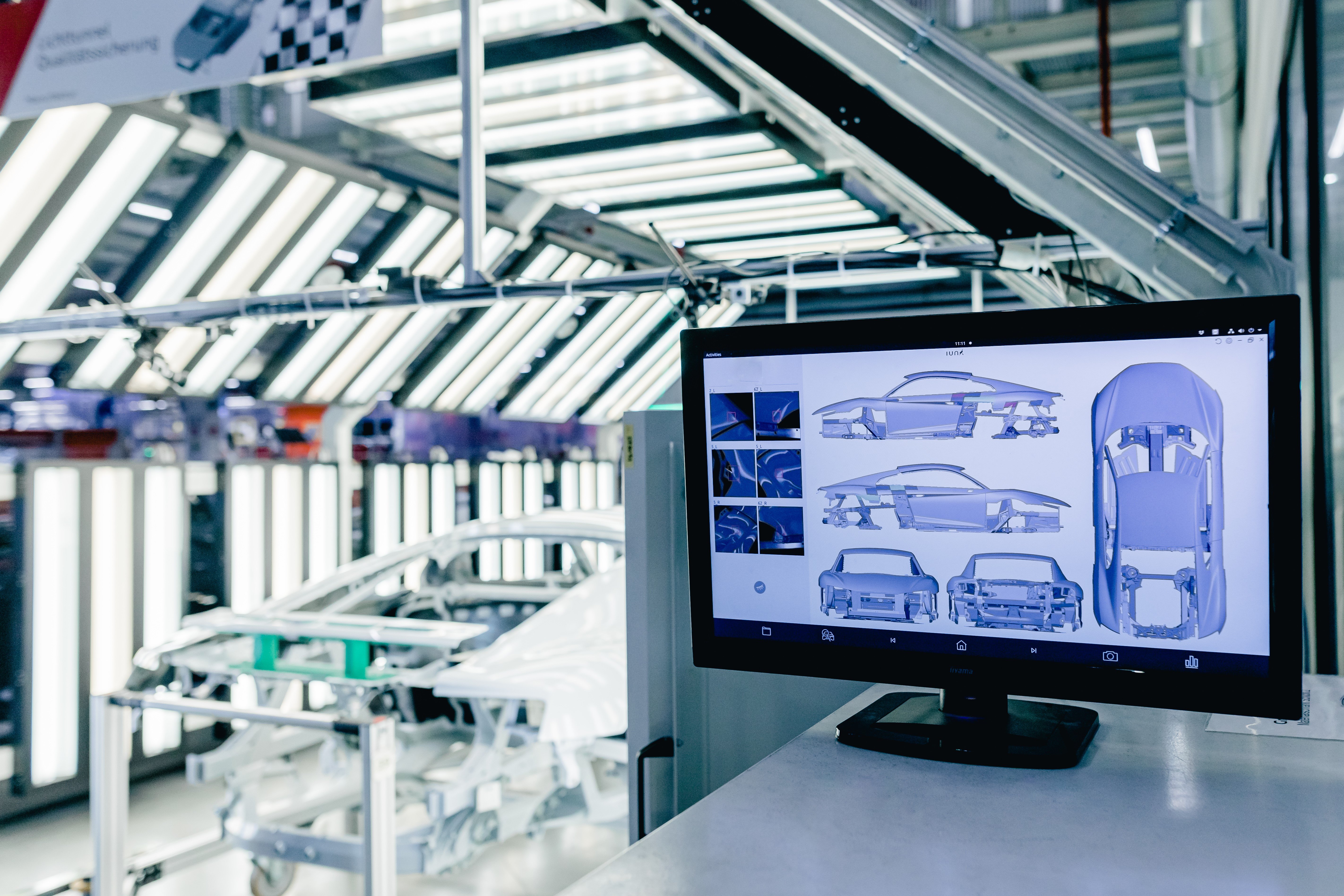IUNA AI Surface Defect Detection - Manufacturing facility with car bodies